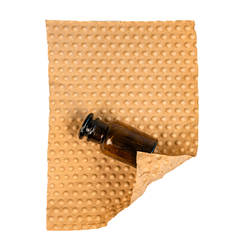 A small brown bottle lies half-wrapped in a single-layer PapairSheet.